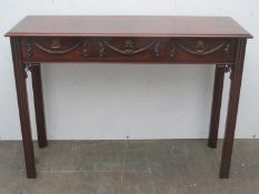 20th century mahogany three drawer console table with carved decoration to front, Approx. 75.5cms