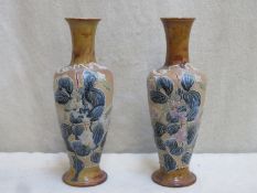 Pair of Doulton Lambeth glazed stoneware bottle neck vases, with tubed lined floral decoration.