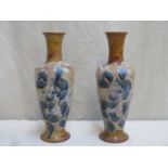 Pair of Doulton Lambeth glazed stoneware bottle neck vases, with tubed lined floral decoration.