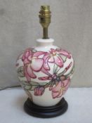 Moorcroft baluster shaped glazed ceramic table lamp, tube lined with floral decoration throughout,
