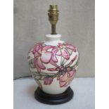 Moorcroft baluster shaped glazed ceramic table lamp, tube lined with floral decoration throughout,