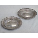 Pair of hallmarked silver wave edged sweet dishes, repouse and piecework decorated with shells and