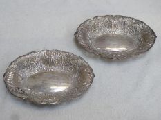 Pair of hallmarked silver wave edged sweet dishes, repouse and piecework decorated with shells and