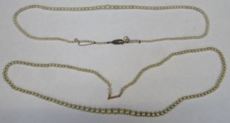 Two strands of graduated pearls, one with a gold clasp and one with a silver clasp