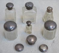 Parcel of various silver topped glass dressing jars plus covers