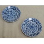 Two similar 18th / 19th century oriental blue and white shallow dishes, both with panels of floral