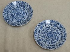 Two similar 18th / 19th century oriental blue and white shallow dishes, both with panels of floral