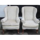 Pair of early to mid 20th century upholstered wing armchairs, on carved supports. Approx. 105cm High