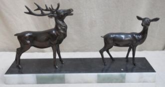 Art Deco style bronze effect figure group, depicting a stag and a fawn, on marble base. Approx. 31cm