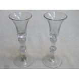 Pair of 18th / 19th century inverted bell form wine glass, with multiple knop air twist stems.