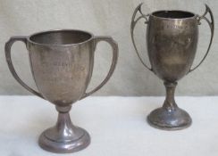 Two hallmarked silver two handled trophies, by walker and hall and Joseph Gloster. Total weight