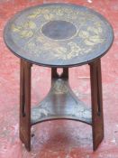 Arts and Crafts style mahogany circular occasional table, with poker work style carved grape and