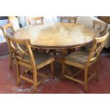20th century inlaid oak circular topped dining table, on quadrafoil supports, with six curved leaves
