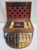 Victorian oak games compendium, possibly by Chad Valley, containing game pieces, Inc. leather