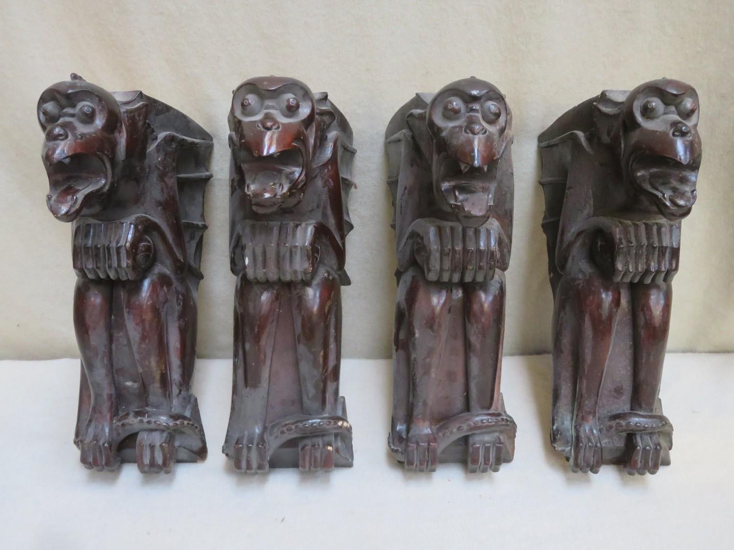 Set of four late 19th/early 20th century carved treen gargoyle form wall brackets, all signed with