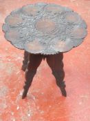 Heavily carved middle eastern style occasional table. Approx. 53cm H x 51.5cm Diameter