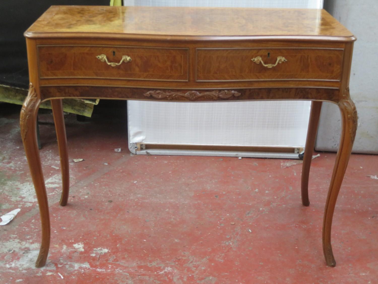 20th century walnut veneered two drawer serpentine fronted side table. Approx. 77cm H x 108cm W x