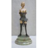 Art Deco style bronze effect ivorine figure depiciting a semi nude dominatrix, mounted on marble