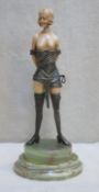 Art Deco style bronze effect ivorine figure depiciting a semi nude dominatrix, mounted on marble