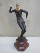 Art Deco style bronze effect and ivorine figure depicting a dancer, mounted on marble base.