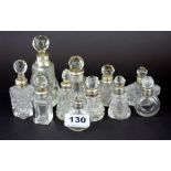 Eleven hallmarked silver mounted perfume bottles, tallest 11.5cm.