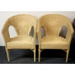 A pair of cane armchairs.