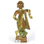 A late 19th century Indian carved wooden deity with rotating arm, H. 34cm.