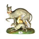 A large 19th century porcelain figure of three greyhounds, H. 27cm L. 29cm. (slightly A/F)