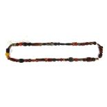 A string of Tibetan carved agate and glass sacred beads collected on pilgrimages, folded L. 55cm.