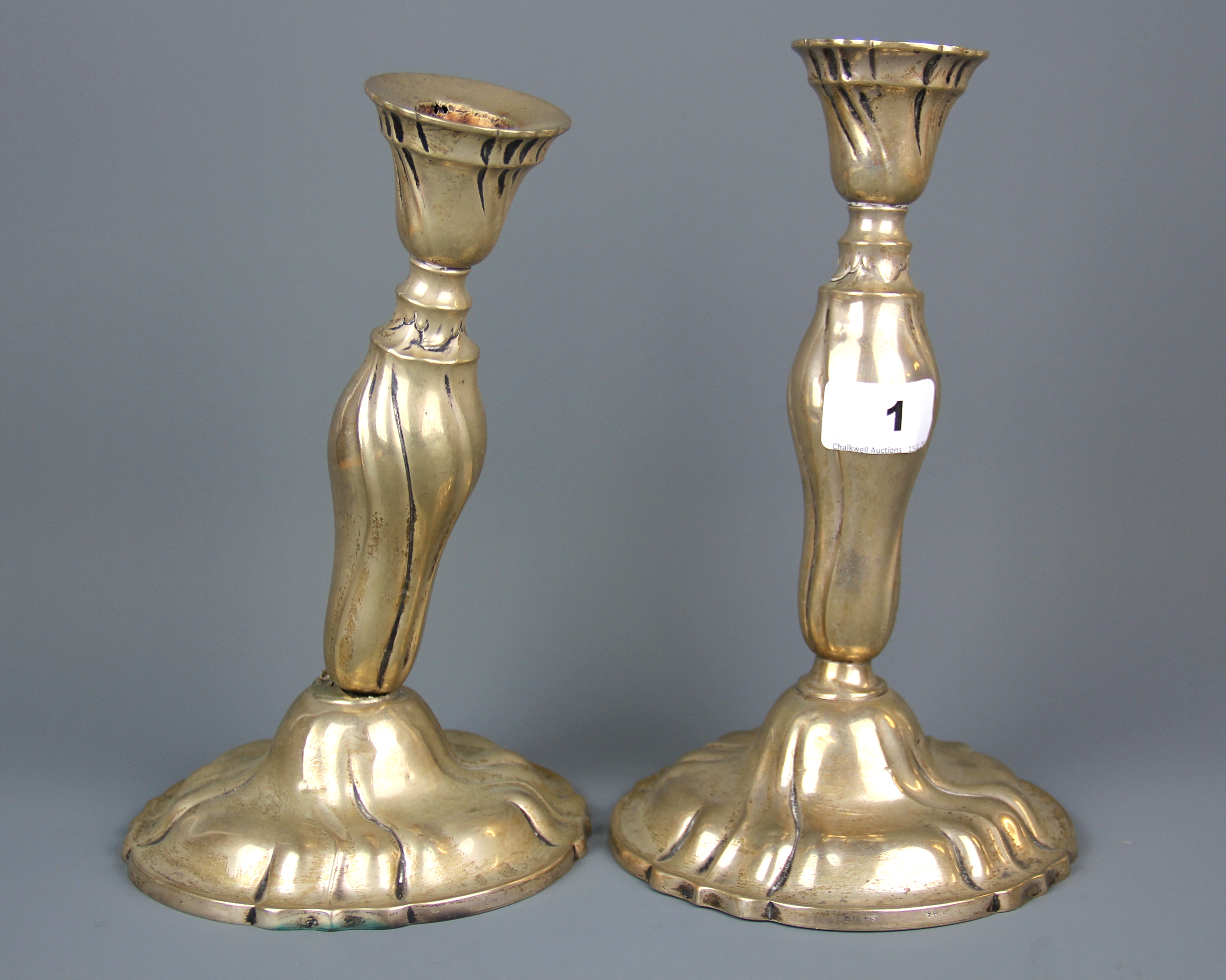 A pair of .830 silver candlesticks, H. 25cm, (one A/F).