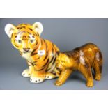 A Portuguese large porcelain figure of a tiger cub, together with a porcelain figure of a bear,