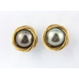 A pair of 18ct gold and black pearl stud earrings, Dia. 1.6cm.