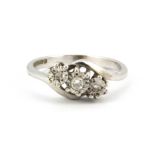 A 9ct white gold three diamond set ring, (O)