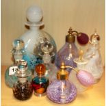 A large Mdina glass perfume bottle and eight further glass perfume bottles.