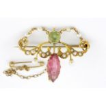 An Edwardian yellow metal (tested minimum 9ct gold) brooch set with peridot, seed pearls and a