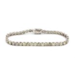 A 14ct white gold tenis bracelet set with brilliant cut diamonds, approx. 10.85ct, L. 20cm.