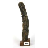 A carved Tribal wooden phallic shaped figure of a nude man, H. 30.5cm.