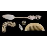 An early carved ivory walking stick handle, Chinese bone spoon and comb.