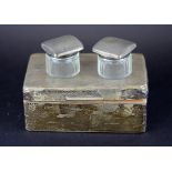 A hallmarked silver cigarette box together with two silver topped glass pots, box size 8.5 x 6 x