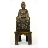 A Chinese bronze figure of a seated noble woman with lotus feet, H. 26cm.