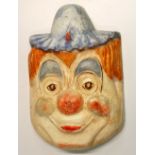 An unusual large hand painted cast metal clown mask, H. 60cm.