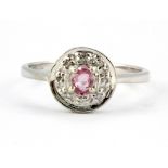 A 9ct white gold cluster ring set with a pink sapphire and diamonds, (M).