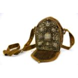 A Tibetan hammered copper and white metal Ga'u (portable shrine) encasing a clay figure of the