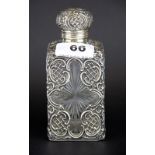 A hallmarked silver decorated cut glass perfume bottle, H. 13cm.