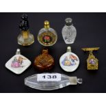 A collection of eight miniature porcelain and glass perfume bottles.