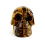 A carved tiger's eye skull, H. 4cm.