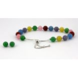 A jade bead adjustable bracelet and matching stud earrings.