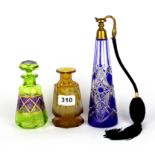 A blue glass perfume atomizer and two coloured glass perfume bottles, tallest 23cm. (one with
