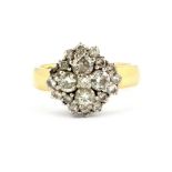 An 18ct yellow and white gold diamond set cluster ring, approx. 1.20ct overall, (one diamond