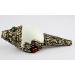 A Tibetan white metal mounted conch shell set with semi-precious stones, L. 14cm.